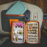 Waterprrof fly box for holding fishing flies for trout and salmon fishing in a bright urnt orange colour